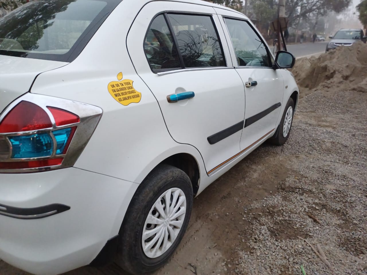 Swift Dzire taxi with contact details for booking services
