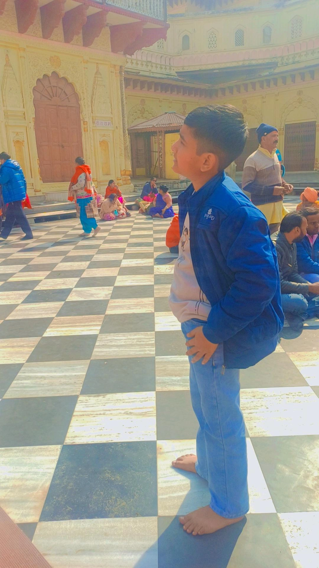 Temple visitor at historic pilgrimage site with checkered marble floor
