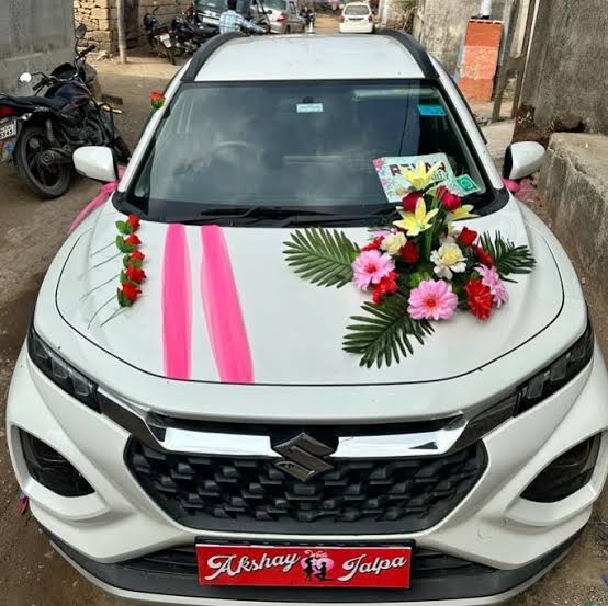 Wedding car adorned with traditional floral decorations