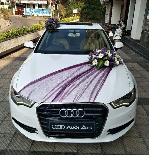 Luxury wedding car decorated with purple floral arrangements